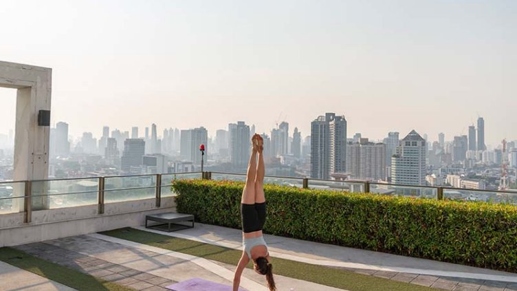 Woman doing yoga on a rooftop