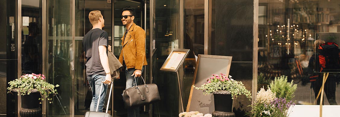 Men talking at the entrance of a hotel